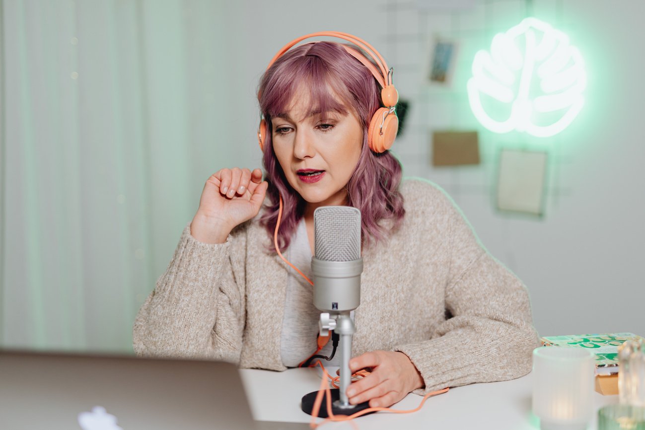 A Woman Talking on a Microphone while Wearing a Headset